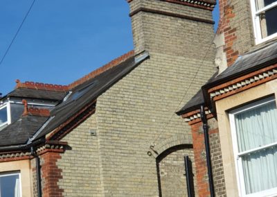 Historic brick chimney with multiple terracotta chimney pots