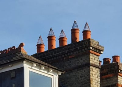 Brick chimney with multiple terracotta chimney pots